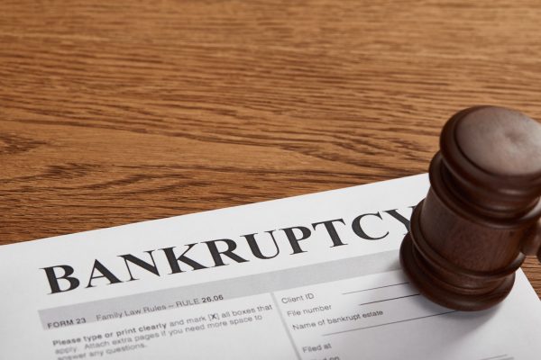 bankruptcy form with wooden gavel on brown wooden table