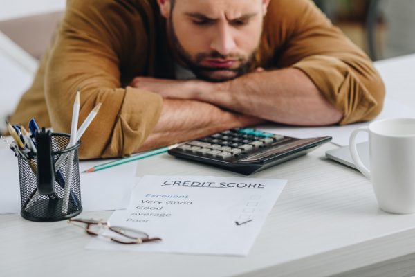 selective focus of sad man with closed eyes lying on table